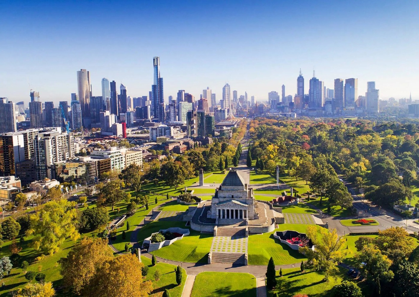 Melbourne's city skyline above parkland and the Shrine of Remembrance