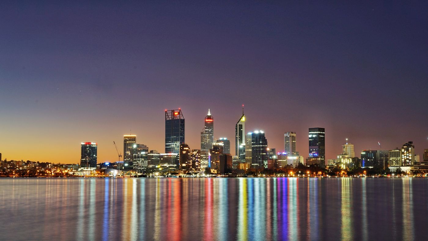 Perth city skyline at twilight, lights reflected in the Swan River