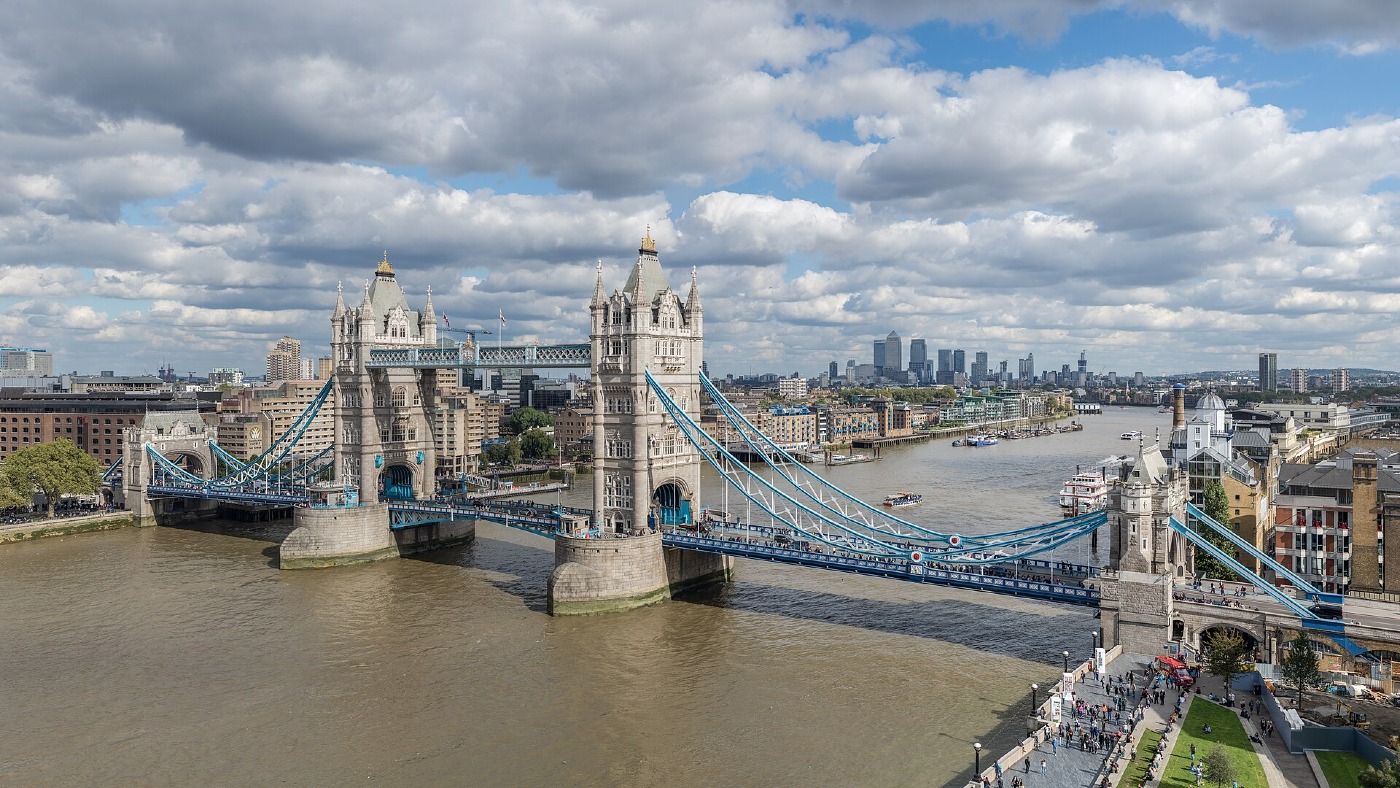 Tower Bridge across the River Thames in London, under a cloudy sky