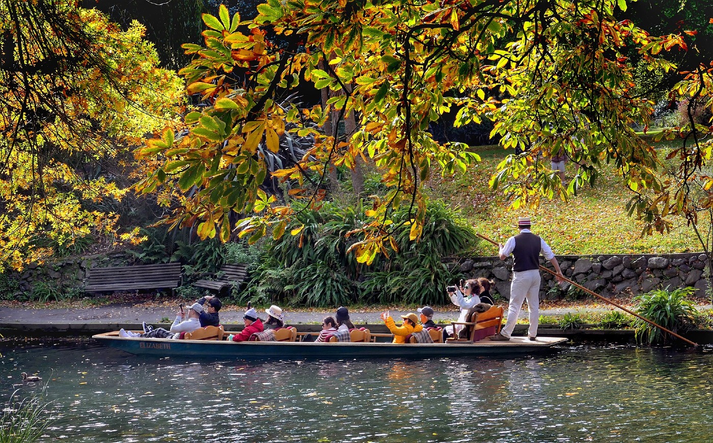 A punt on the Avon River in Christchurch, under autumn trees