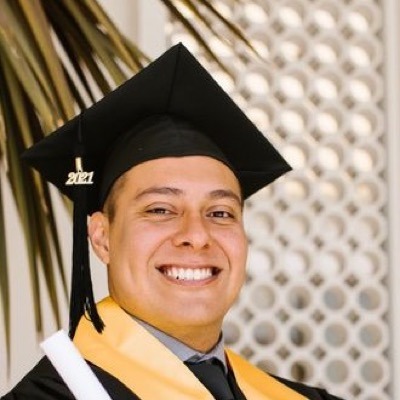 Jordan Miller, smiling in a graduation cap and gown