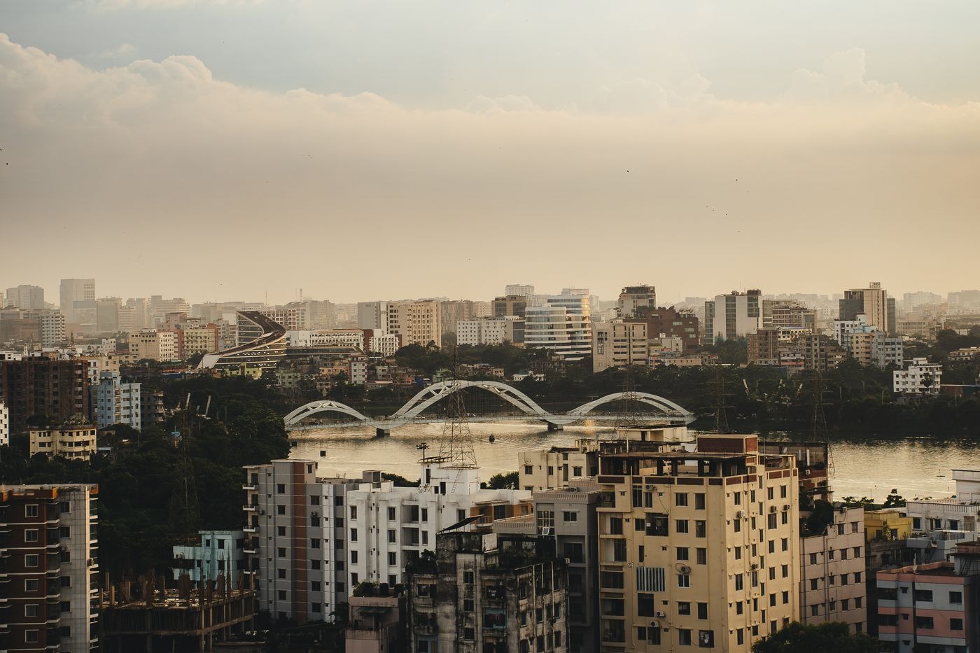 Dhaka skyline with the Hatirjheel bridges under a hazy evening sky